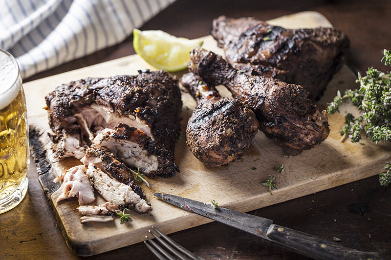 In my experience, Jerk Chicken has always been marinated with fresh and dry ingredients to allow for flavour to be imparted into a large portion of the meat. Pork and goat are also commonly cooked with jerk spices in Jamaica.