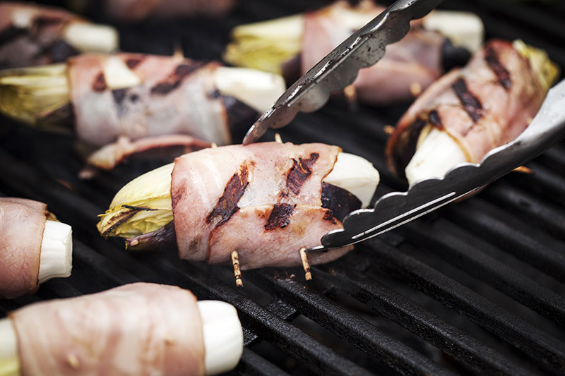 About 2 -3 minutes per side should do it. make sure that your grill is well oiled as to avoid the bacon from sticking to the grill and tearing.
