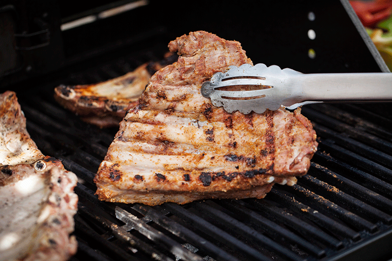 When the ribs have a good sear and light lines on one side, it's time to flip them. Sear them in the same manner on the second side and them lower the barbecue to its lowest heat setting.