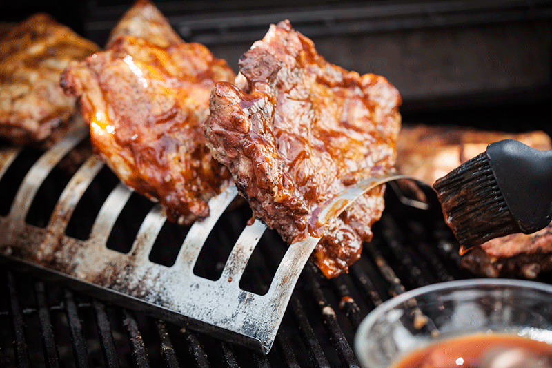 Once the ribs are fully basted, front and back, with the sauce. It's time to clove the hood of the grill and to cook them for a further 30 to 45 minutes. You can baste them a second time, half-way though the cooking time and you'll know when they're done when the tear away from the bone easily. 