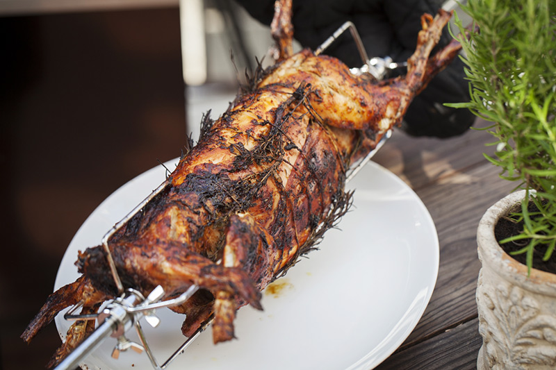 When the rabbit is lightly charred, it's time to remove it from the rotisserie and allow it to rest for about 5 minutes before removing it from the spit. 